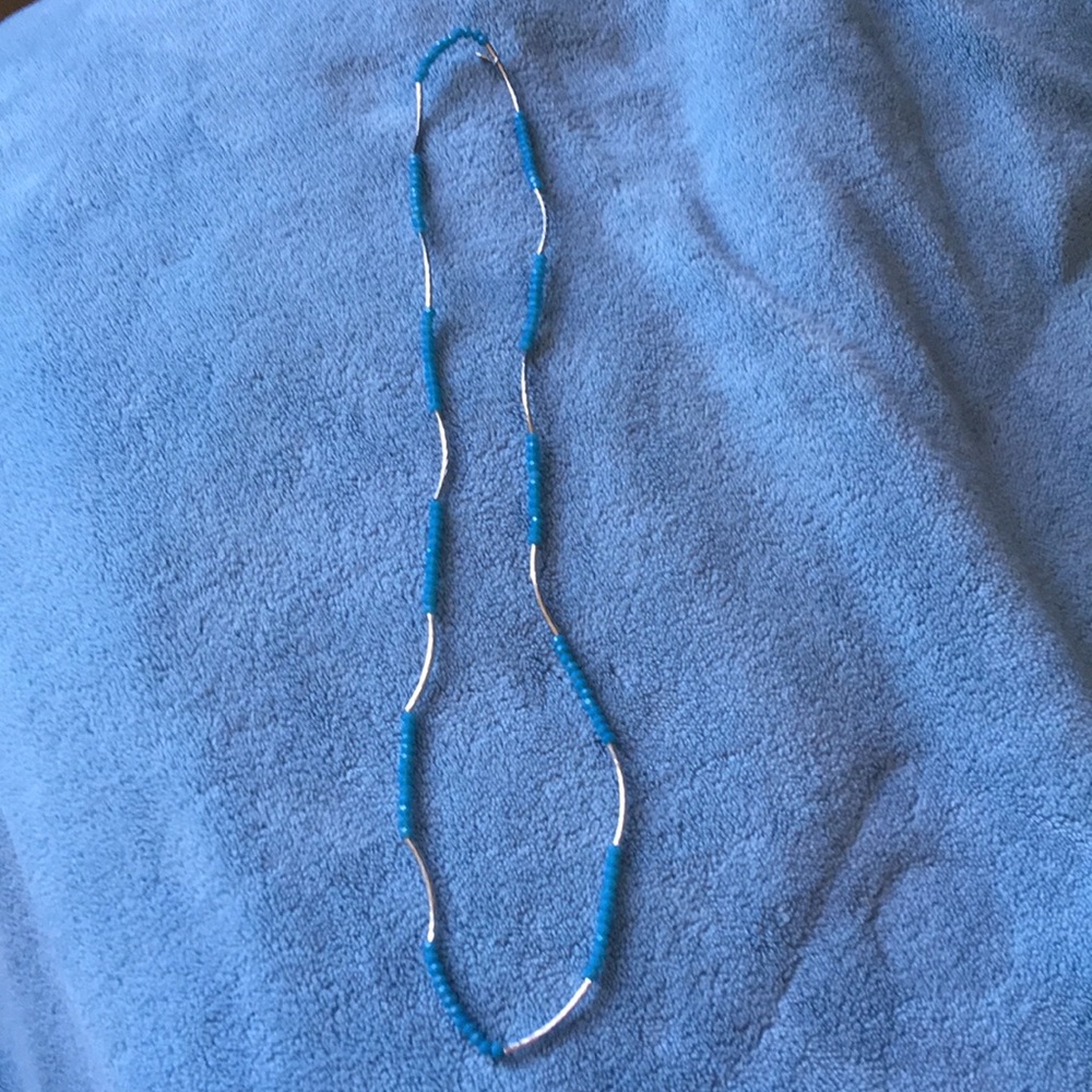 Silver toned with light blue bead necklace.
